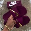 blue nike slides with gold check